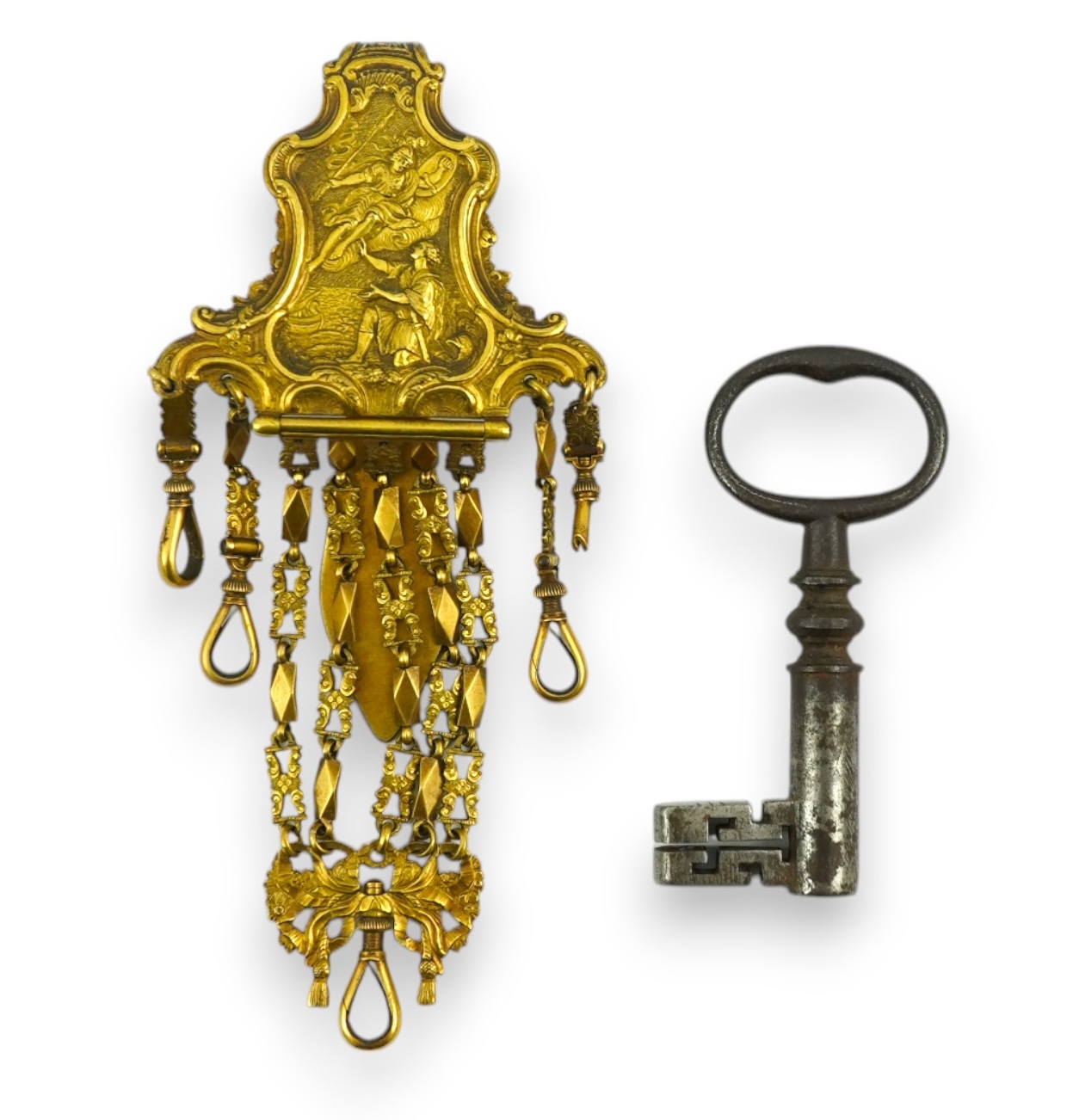 A late 18th century German gilt metal chatelaine and a steel key, chaterlaine 14cm long. Condition - a link is missing on one chain